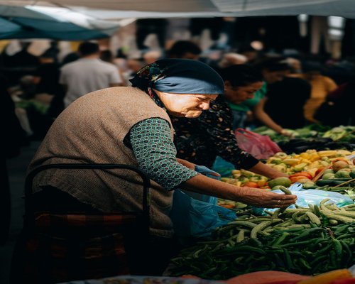 A person buying vegetables at a local traditional market