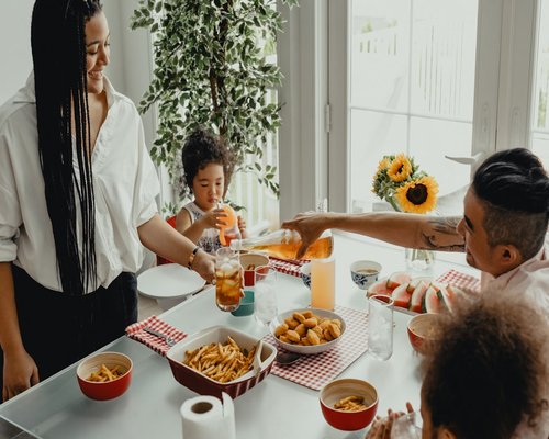 Family enjoying a meal together at a dining table
