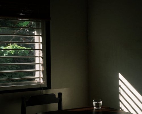 A glass of water near a window with sunlight